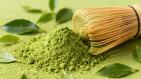 Premium Japanese matcha powder in a bamboo whisk.
